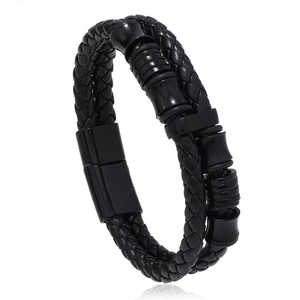 Detail of black woven leather bracelet showing the black metal magnetic clasp and texture
