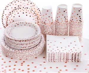 Detail of rose gold polka dot disposable paper plates and cups set for wedding party