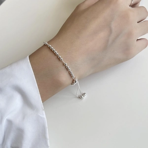Close-up of minimalist S925 sterling silver bead bracelet with adjustable slider on wrist