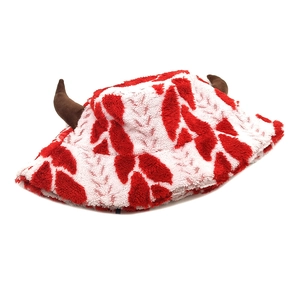 Detail of plush Christmas bucket hat with red white fur and 3D brown antlers decoration