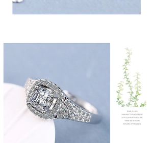 Macro shot of silver ring with square-cut cubic zirconia and micro-pave split shank
