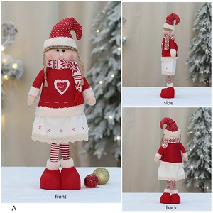 Front, side, and back views of a knitted Christmas girl doll with a heart pattern