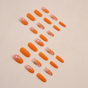 Oval orange matte press-on nails with solid colors and hand-painted citrus slice designs