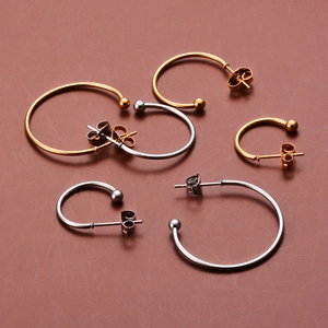 Polished gold and silver C-shaped hoop earrings with ball heads in three various sizes