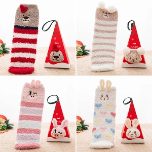 Macro view of Christmas coral fleece socks set with cute animal triangular gift boxes