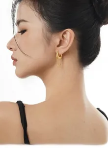 Detailed view of S925 silver gold hoop earrings with irregular texture and tassel chains