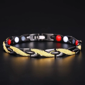 Detailed close-up of men's black and gold dragon link bracelet with magnetic inserts