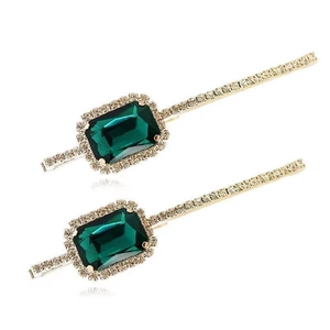Elegant gold hair clips with emerald green crystals and sparkling rhinestones for women