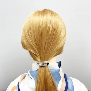 Sleek silver metal geometric hair tie clip for low ponytail styling on blonde hair