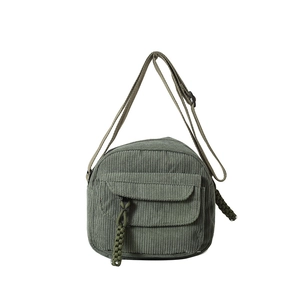 Minimalist dark green corduroy shoulder bag with zipper pocket and adjustable strap