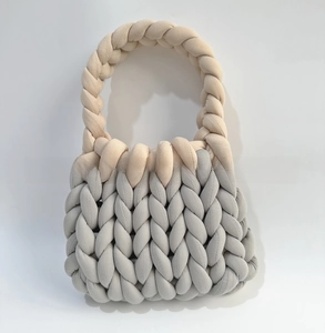 Detail of chunky cotton tube yarn showing two-tone grey and beige hand-knitted texture