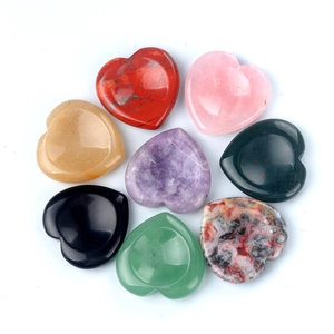 Detailed top view of seven assorted heart-shaped healing stones on a white background