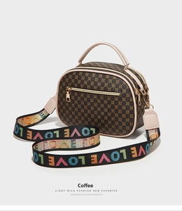 Detail of Boston bag showing retro round patterns and colorful rainbow LOVE woven strap
