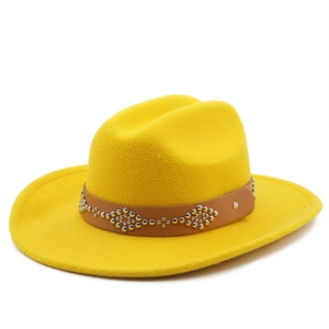 Detail of yellow wool fedora hat with brown leather band and silver rivet accents