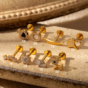 Detailed set of eight G23 titanium labret studs with gold plating and zircon inlay