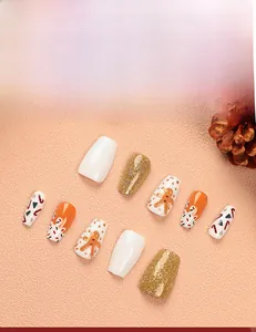 Detailed view of Christmas press-on nails featuring gingerbread man and snowflake art