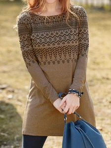 Detail of bohemian leaf pattern and geometric stripes on brown long sleeve dress