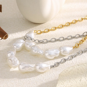 Detail of baroque pearl and mixed gold-silver chain necklace with luxury texture