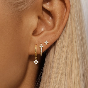Detail of s925 sterling silver evil eye earring set with flower charms and cubic zirconia