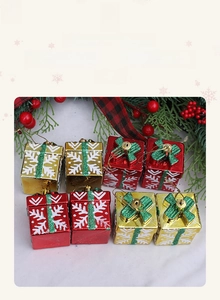 Detailed view of red and gold Christmas gift box ornaments with glittery green bows