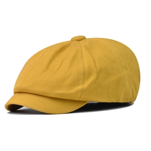 Classic bright yellow cotton newsboy cap with a stylish flat brim and paneled design