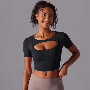 Close-up of black sports crop top with cutout mesh design and layered racerback style