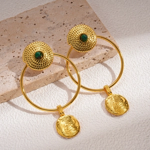 Close-up of 24K gold plated earrings with hammered texture and green malachite inlay