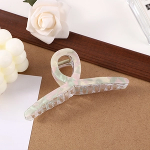 Elegant mint green marble pattern hair claw clip displayed with lifestyle accessories