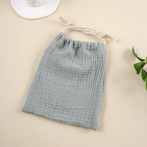 Detail of light gray muslin cotton drawstring storage bag with natural crinkle texture