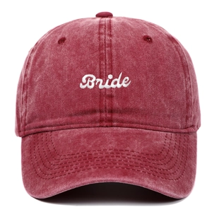 Washed red cotton baseball cap with white Bride embroidery and curved brim in front view