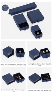 Macro view of sapphire drawer-style jewelry gift boxes with satin pull ribbons