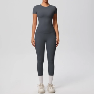 Detail of dark grey seamless yoga set featuring slim fit short sleeve top and leggings