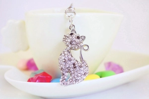 Macro shot of silver metal cat keychain with sparkling rhinestones and crystal details