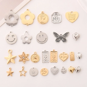 Assorted gold and silver zinc alloy charms including flowers, hearts and star shapes