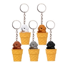 Set of five colorful poodle ice cream cone resin keychains on a clean white background