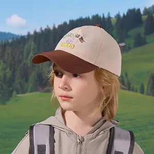Kids color-block baseball cap with GOOD embroidery on a scenic mountain outdoor background