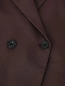 Close-up of brown blazer twill fabric showing collar detail and black buttons