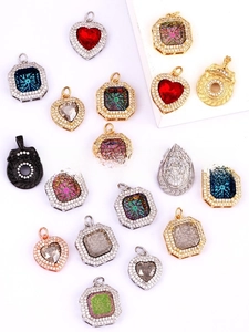 Detailed flat lay of gold-plated pendant charms in heart and snowflake geometric shapes