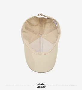 Detail of beige baseball cap featuring breathable white mesh lining and interior laser-cut vents