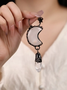 Macro shot of bronze moon and star pendant with white quartz and clear crystal detail