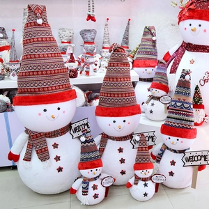 Giant plush snowman Christmas decorations in various sizes with ethnic knit hats and scarves