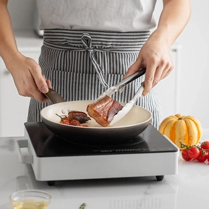 White heat-resistant silicone food tongs with stand for non-stick cookware in kitchen