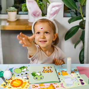 Girl creating cute DIY animal face-changing stickers with turtle, lion and tiger patterns