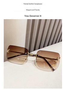 Close-up of rimless gradient brown sunglasses featuring diamond-set butterfly metal accents