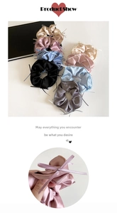 Detail of satin scrunchies with ribbon bows in pastel colors like pink and blue