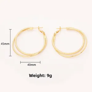Detail view of double-layer gold hoop earrings with matte and polished finish textures