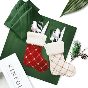 Close-up of mini gold sequin plaid Christmas stockings used as festive cutlery holders