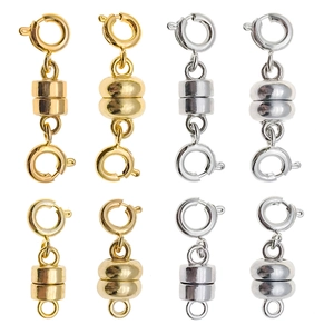 Detailed close-up of cylindrical gold and silver magnetic jewelry clasps for DIY crafts