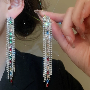 Close-up of elegant long tassel earrings featuring colorful sparkling cubic zirconia stones