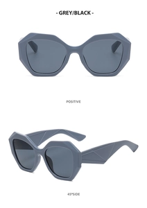 Detail view of grey square geometric sunglasses with matte frame and dark lenses